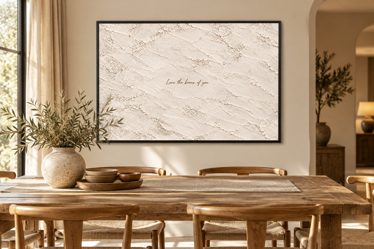 Landscape quote artwork in a black frame in a dining room