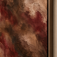 Close-up of burgundy and brown artwork in a dark wood float frame