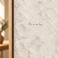 Close-up of the quote artwork in a light wood float frame