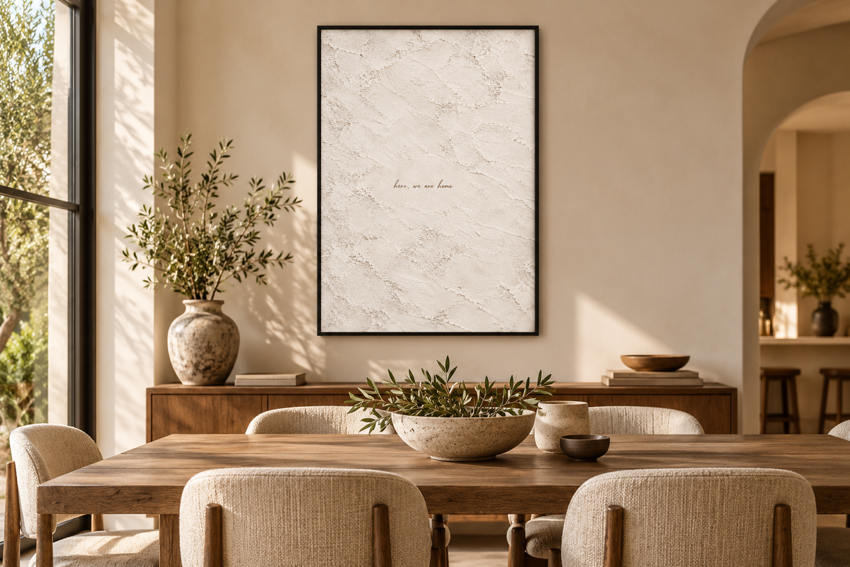 Here We Are Home artwork in a black frame in a dining room