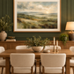 Mounted landscape print on a deep green dining room wall