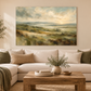 Green landscape canvas above a sofa in a neutral living room